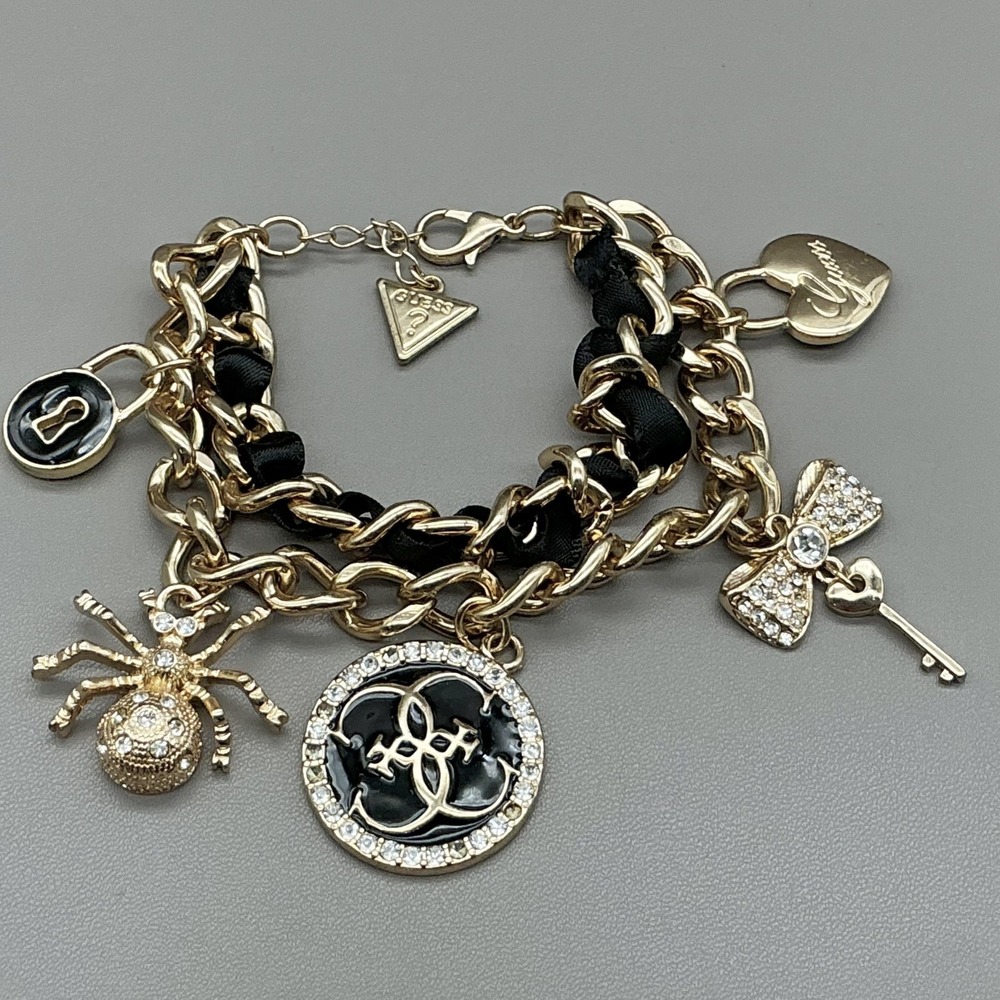 Guess Bracelet Gold Tone Black Enamel Crystal Spider Logo Charm Womens Fashion